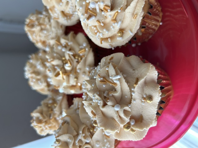 cupcakes decorated with frosting and gold sprinkles